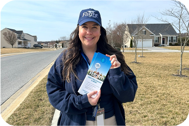 Attractive Flight Fiber employee holding door tag
