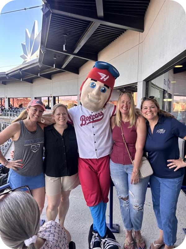 Antietam Broadband team at Boxcars game taking picture with mascot